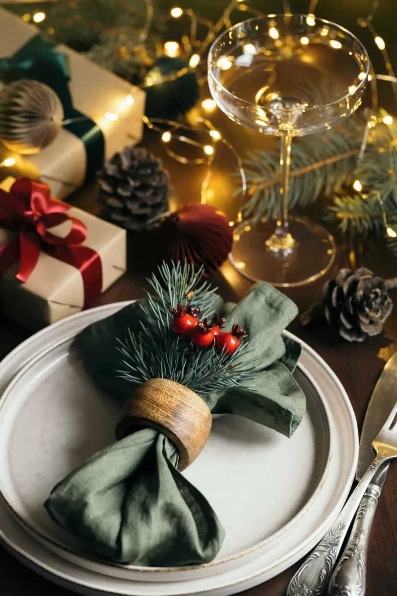 Christmas table with a gift and fir branches